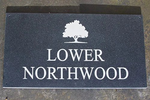 This engraved house sign was made using the stone effect black quartz corian. Corian House Sign