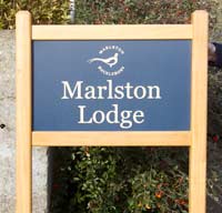 Simple entrance sign with bevelled posts tops