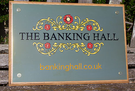 Large engraved brass plaque with paint-fill in four colours.