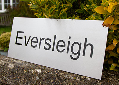 Large stainless steel house sign which was to be fixed to black painted aluminium posts.