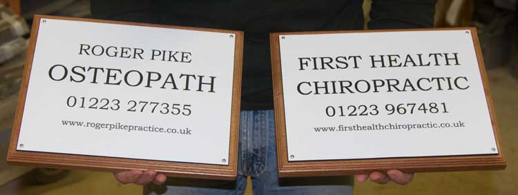 White acrylic plaques with black engraved text