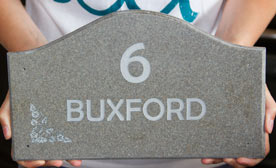 Shaped engraved house name plate made in stone-like corian