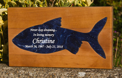 Engraved corian fish inset into red cedar