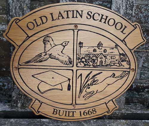 Wooden sign created in the shape of the school crest