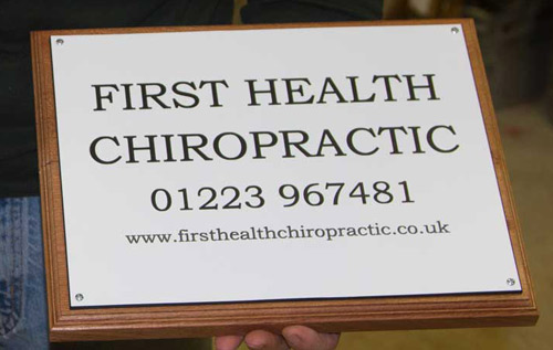 Engraved business plaque made in a white and black acrylic laminate