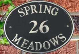 Cast aluminium house sign with polished lettering.