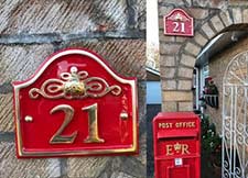Cast brass house number signs in various shapes.