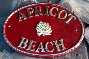 Oval maroon cast brass sign
