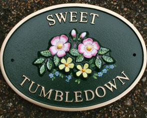 Cast oval house sign with dog rose motif