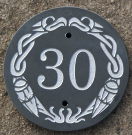 A celtic slate house number using round celtic border.