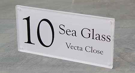 Clear acrylic sign with sand blast effect backing vinyl.