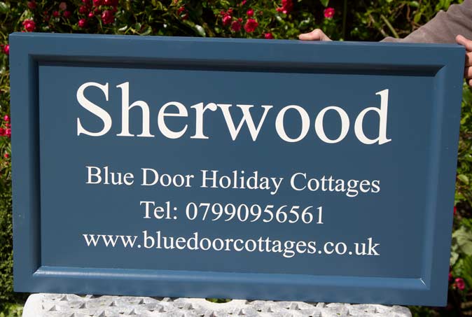 Painted wooden sign in Stiif Key Blue with a frame edge