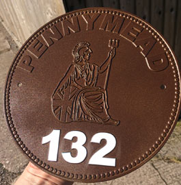 House number sign made to look like old penny