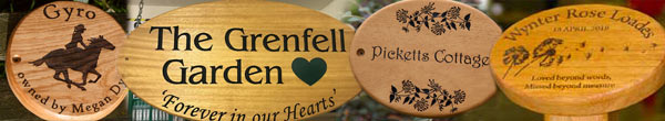 Round and oval wooden signs and memorial plaques.