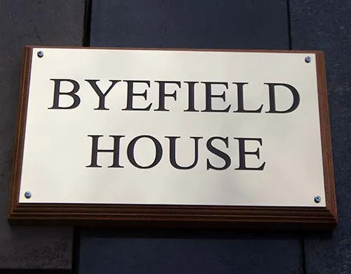 This type of sign is very traditional for town houses Brass House Signs