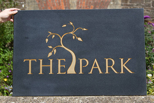 Corian sign with gold letters