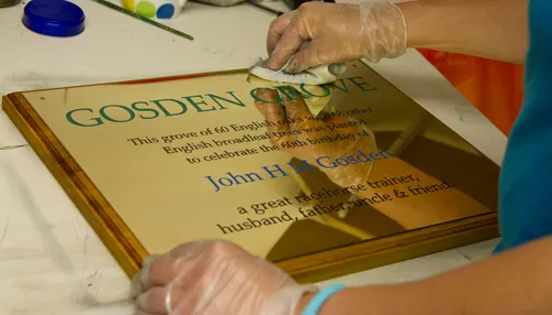 Working on engraved brass plaque