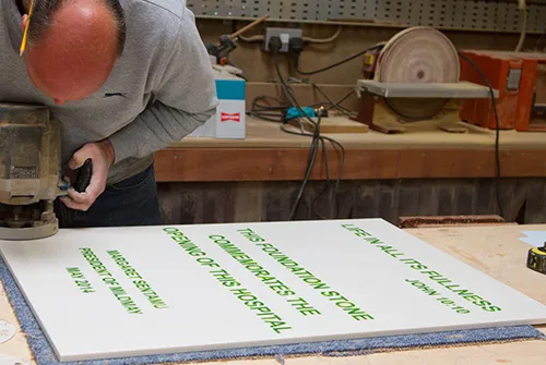 working on an engraved corian sign