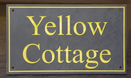 title here Slate house sign with letters painted in Farrow and Ball Yellowcake