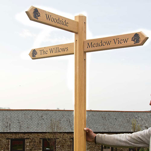 Wooden direction arrow signs to improve the visitor journey, made by The Sign Maker.