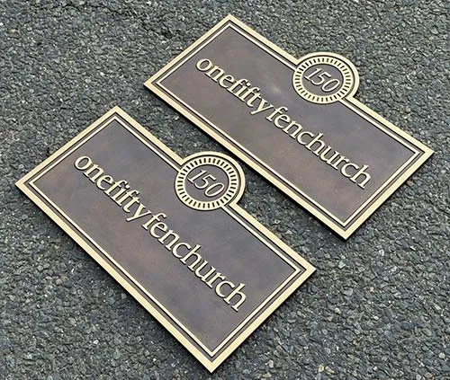 These are patinated bronze with a smooth finish Cast Bronze Siigns