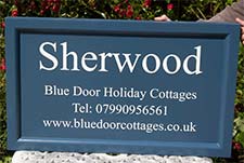 Stiffkey Blue painted sign for holiday cottages
