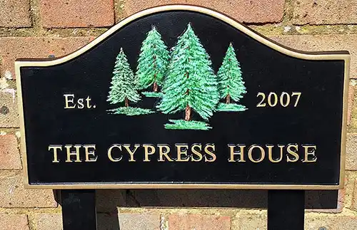 Arch top cast house sign on posts