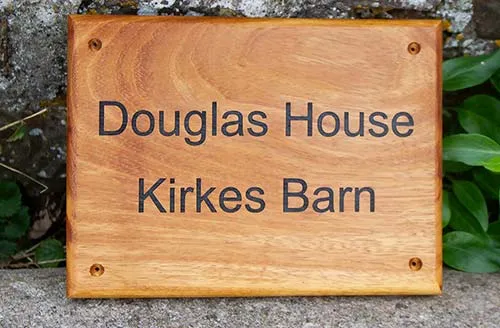 title here Iroko Wood House Sign