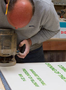 Paul routering a large corian sign
