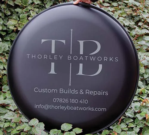 Cut vinyl lettering for the longest lasting wheel covers. Grey Lettering on Black Wheel Cover