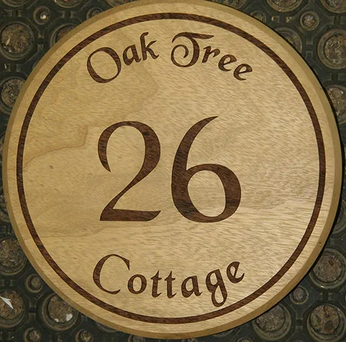 title here round wooden house number sign