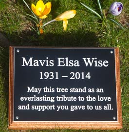 Simple black and white memorial plaque on tree stake