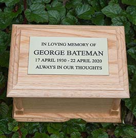 Wooden ashes casket with engraved brass plaque.