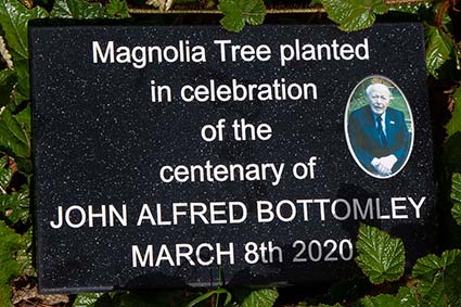 Engraved corian plaque with porcelain photo inset.