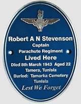 Oval zinc memorial plaque with raised letters.