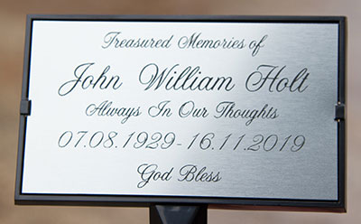 Metallic silver plaque in plaque holder.