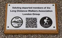 Stone-like corian plaque on a wooden backing board.