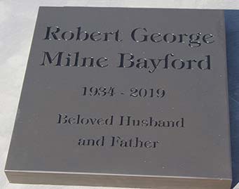 Slate memorial with black text.
