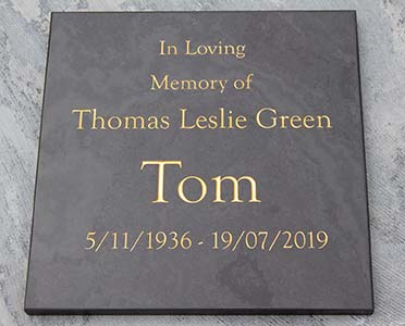 Slate memorial with gold text.