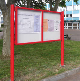 Two door notice board on posts in non standard red - RAL 3020