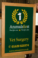 Full colour hanging sign framed in oak