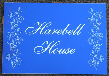 Small engraved blue aluminium hose sign