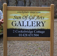 Full colour entrance sign framed with oak on posts.