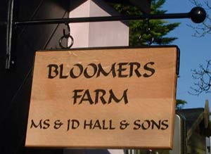 Farm sign on wrought iron bracket.