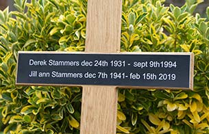 Laser engraved black plaque on oak cross.