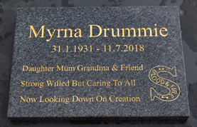 Dark grey granite memorial with gold text.