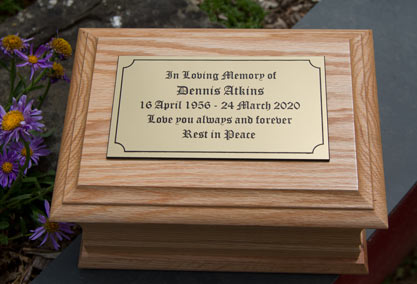 Standard oak casket with gold acrylic plaque.