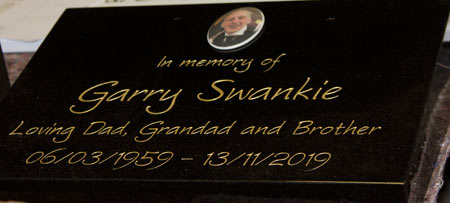 Full colour porcelain plaque on black granite wedge.