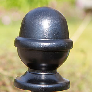 Painted oak post top in shape of an acorn.