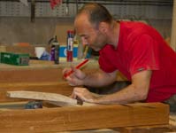 Carpenter at work on oak sign